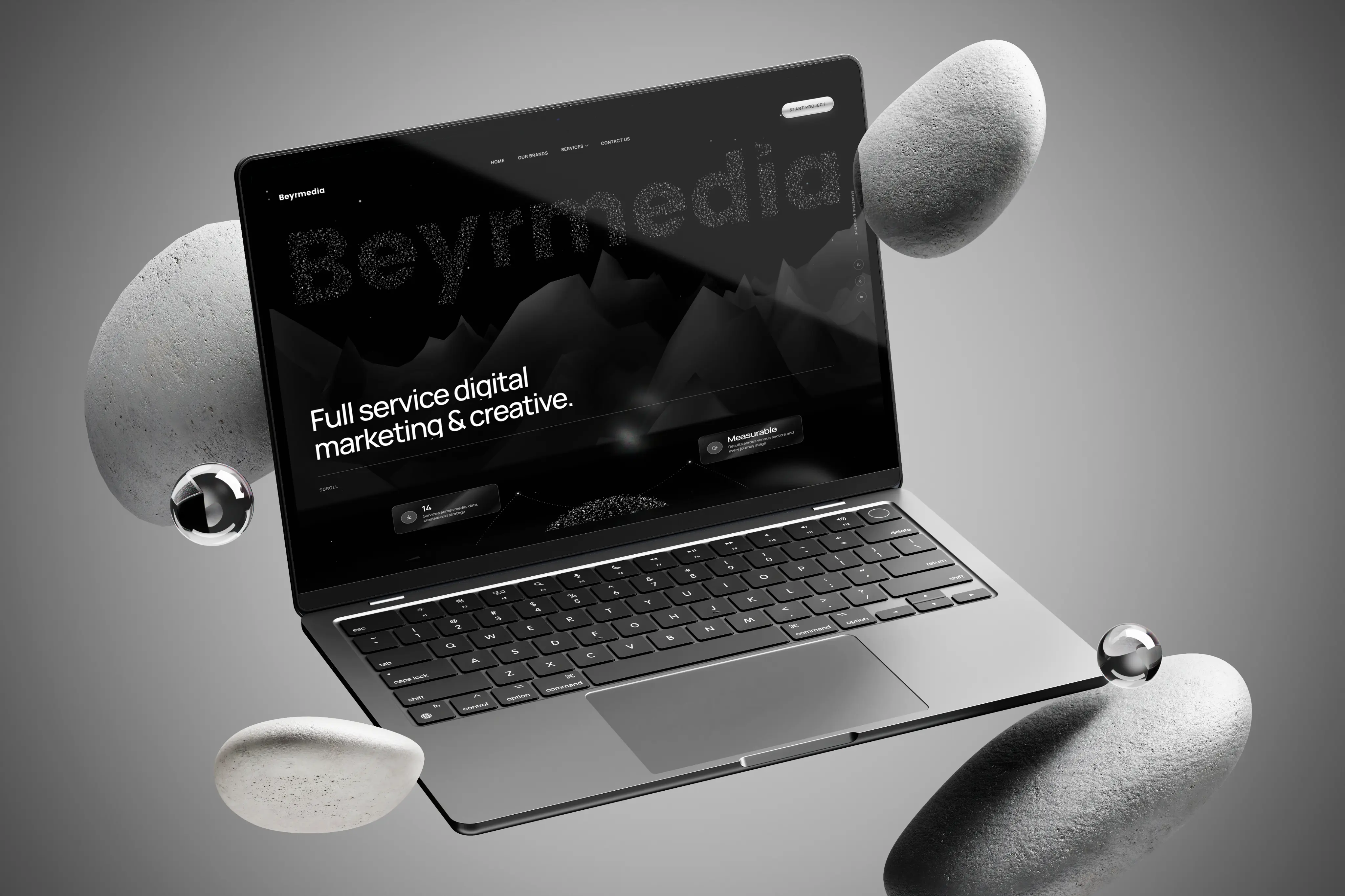 Beyrmedia website displayed on a laptop with floating stones